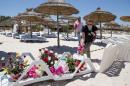 People lay flowers at the site of a shooting attack on the beach in front of the Riu Imperial Marhaba Hotel in Port el Kantaoui, on the outskirts of Sousse south of the capital Tunis, on June 27, 2015