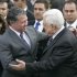 King Abdullah II of Jordan, left, is greeted by Palestinian President Mahmoud Abbas, right, as he arrives in the West Bank city of Ramallah, Monday, Nov. 21, 2011. King Abdullah II is paying a rare visit to the West Bank to show support for Palestinian President Mahmoud Abbas. Monday's trip comes as the two moderate leaders seek rapprochement with the Islamic militant Hamas. (AP Photo/Majdi Mohammed)