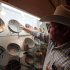 This Aug. 15, 2011 image shows dealer Bobby Smrkovsky adjusting his display at the Whitehawk Antique Show, the nation's largest and longest-running Indian artifacts show, in Santa Fe, N.M. Many dealers and collectors who gathered for the annual event said they have been struggling to rebuild their reputations after federal raids in the Four Corners region in 2009 cast a cloud over the market. (AP Photo/Susan Montoya Bryan)