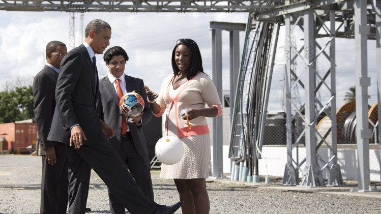 U.S. President Barack Obama demonstrates "the Soccket Ball," which uses kinetic energy to provide power to charge a cell phone or power a light, during an event at the Ubungo power plant to promote energy innovation on Tuesday, July 2, 2013, in Dar Es Salaam, Tanzania. The president is traveling in Tanzania on the final leg of his three-country tour in Africa. (AP Photo/Evan Vucci)