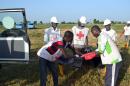 Officials of Red Cross try to remove a dead body at the scene of the blast in Miduguri on October 16, 2015