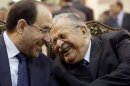 FILE - In this June. 27, 2009 file photo, Iraq's Prime Minister Nouri al-Maliki, left, and President Jalal Talabani, right, react, at a ceremony marking the death of Mohammed Baqir al-Hakim in Baghdad, Iraq. President Jalal Talabani's departure from Iraq's political life comes at a worse time for his troubled nation, under threat from mounting tensions between Kurds, Sunnis and Shiites. (AP Photo/Hadi Mizban, File)