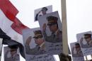 Posters of Army Chief Sisi are seen as supporters of the army protest against ousted Islamist President Mursi and members of the Muslim Brotherhood in Cairo