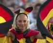 Germany supporter waves flags during public screening of Germany vs Portugal Euro 2012 soccer match in Berlin