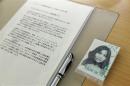 A picture of abduction victim Taguchi lays next to the text of his brother Izuka before a session of the Human Rights Council on the report of the Commission of Inquiry on Human Rights in North Korea at the UN in Geneva