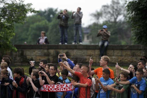 Soccer fans take pictures of Netherland's players as they arrive at Sheraton hotel in Krakow