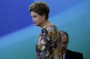 Brazil's President Rousseff walks past Brazil's Chief of Staff Mercadante during a ceremony to reappoint Brazil's Prosecutor-General Janot to the position of Prosecutor-General in Brasilia