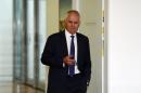 Federal Communications Minister Malcolm Turnbull, a millionaire lawyer and former investment banker, walks out of a government party room meeting in Canberra's Parliament House