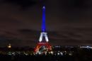 The Eiffel Tower is illuminated with the colors of the French national flag in tribute to the victims of the November 13 Paris terror attacks, in Paris on November 17, 2015