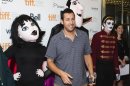 Actor Sandler poses with mascots of characters from "Hotel Transylvania" at the film's gala presentation at the 37th Toronto International Film Festival