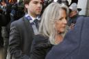 Former first lady Maureen McDonnell, right, arrives at federal court with her son Bobby for her sentencing on corruption charges in Richmond, Va., Friday, Feb. 20, 2015. Federal prosecutors have recommended an 18-month prison term, six months less than former Gov. Bob McDonnell received when he was convicted on 11 counts last month. (AP Photo/Steve Helber)