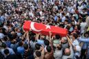 People carry the coffin of Hamidullah Safar covered in a Turkish national flag on June 30, 2016 in Istanbul, two days after a suicide bombing and gun attack targeted Istanbul airport