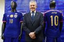 Japan's football coach Javier Aguirre stands next to the football uniforms his team will use at the Asian Cup after he announced the squad at a press conference in Tokyo on December 15, 2014