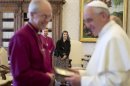 Pope Francis exchange gifts with Archbishop of Canterbury Welby, in front of wife Caroline during a private audience at Vatican