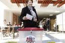 Latvia's Prime Minister Straujuma casts her ballot during parliamentary elections in Jaunmarupe