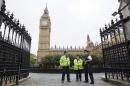 Police officers stand guard outside the Houses of Parliament in central London on September 26, 2014