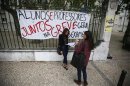 Students wait near a banner for the arrival of their teachers to conduct their university entrance exams in Lisbon