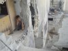 A boy sits at his parents' house, damaged by shelling by forces loyal to Syria's President Bashar al-Assad, in Talbiseh