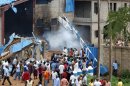 People gather outside a church following a blast in Kaduna, Nigeria, Sunday, June 17, 2012. Three church blasts rocked a northern Nigerian state Sunday, officials said, prompting protests in a state that has previously been strained by religious tensions. (AP Photo/Olu Ajayi)