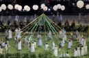 Performers take part in a pre-show at the Olympic Stadium before the opening ceremony of the London 2012 Olympic Games