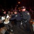 Occupy Wall Street protesters clash with police near Zuccotti Park after being ordered to leave their longtime encampment in New York, early Tuesday, Nov. 15, 2011. At about 1 a.m. Tuesday, police handed out notices from the park's owner, Brookfield Office Properties, and the city saying that the park had to be cleared because it had become unsanitary and hazardous. Protesters were told they could return, but without sleeping bags, tarps or tents. (AP Photo/John Minchillo)