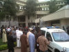 This image released by Saharareporters shows ambulances and rescue workers after a large explosion struck the United Nations' main office, background, in Nigeria's capital Abuja Friday Aug. 26, 2011, flattening one wing of the building and killing several people. A U.N. official in Geneva called it a bomb attack. The building, located in the same neighborhood as the U.S. embassy and other diplomatic posts in Abuja, had a huge hole punched in it.   (AP Photo/Saharareporters)