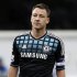 John Terry of Chelsea looks over at the Queens Park Rangers fans as they chant insults at him during an injury break in their FA Cup soccer match at Loftus Road in London