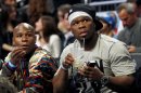 Boxer Floyd Mayweather Jr, left, and performer 50 Cent sit courtside during the NBA All-Star Shooting Stars basketball competition in Orlando, Fla., Saturday, Feb. 25, 2012. (AP Photo/Lynne Sladky)