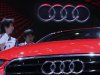 Visitors look at an Audi A3 on media day at the Paris Mondial de l'Automobile