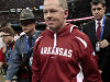 FILE - In this Jan. 4, 2011, file photo, Arkansas coach Bobby Petrino, followed by his security detail Arkansas State Police Captain Lance King, left, walks of the field after Arkansas' 31-26 loss to Ohio State in the Sugar Bowl NCAA college football game at the Louisiana Superdome in New Orleans. The Bobby Petrino saga has left unsavory trails of deceit, including a troubling perception about the relationship between coaches and the police who handle security for them around the Southeastern Conference _ a region where college football reigns supreme. When Petrino wrecked his motorcycle in the hills outside of Fayetteville on April 1, the person he trusted most to handle the immediate aftermath was King, who provided security for the team at Razorback games. (AP Photo/Gerald Herbert, File)