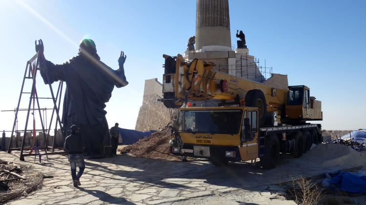This Oct. 14, 2013 photo provided by the St. Paul's and St. George's Foundation shows workers preparing to install a statue of Jesus on Mount Sednaya, Syria. In the midst of a civil war rife with sectarianism, a 12.3-meter (40-foot) tall, bronze statue of Jesus has gone up on a Syrian mountain, apparently under cover of a truce among three factions - Syrian forces, rebels and gunmen in the Christian town of Sednaya. (AP Photo/Samir El-Gadban, St. Paul's and St. George's Foundation)