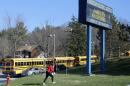A woman walks onto the campus of the Franklin Regional School District where several people were stabbed at Franklin Regional High School on Wednesday, April 9, 2014, in Murrysville, Pa., near Pittsburgh. The suspect, a male student, was taken into custody and being questioned. (AP Photo/Gene J. Puskar)