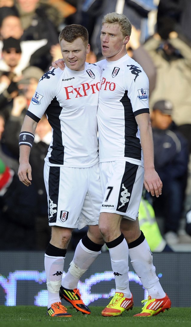 Fulham's Pavel Pogrebnyak celebrates with teammate John Arne Riise after scoring during their English Premier League soccer match against Stoke City at Craven Cottage in London