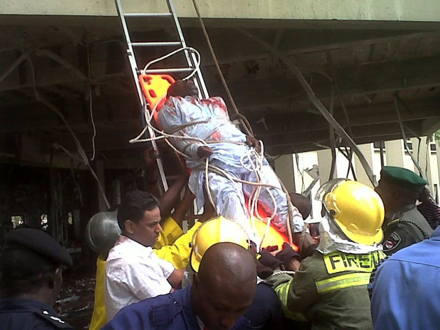 This image released by Saharareporters shows an injured man being stretchered down a ladder by firefighters after a large explosion struck the United Nations' main office in Nigeria's capital Abuja Fr