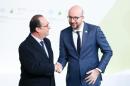 French president Francois Hollande (L) greets Belgium prime minister Charles Michel (R) as he arrives for the COP21 World Climate Change Conference in Le Bourget, north of Paris, on November 30, 2015