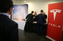 People attend the Tesla and Space X booth at TechFair LA, a technology job fair in Los Angeles