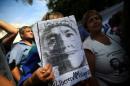 A woman holds a portrait of leader of the Tupac Amaru social welfare group Milagro Sala in Buenos Aires
