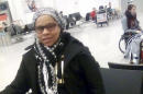 In this photo made Tuesday, March 22, 2016, and provided by her family, Elita Borbor Weah stands in the Brussels Airport in Brussels, Belgium, shortly before bombs went off nearby. Weah, who was on her way to Rhode Island for her stepfather's funeral, texted the photo of herself to family members just before she died in the attack. (Courtesy of the Weah Family via AP)