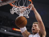 Los Angeles Clippers forward Blake Griffin, right, dunks as Oklahoma City Thunder guard Reggie Jackson looks on during the first half of an NBA basketball game in Los Angeles, Monday, Jan. 30, 2012. (AP Photo/Chris Carlson)