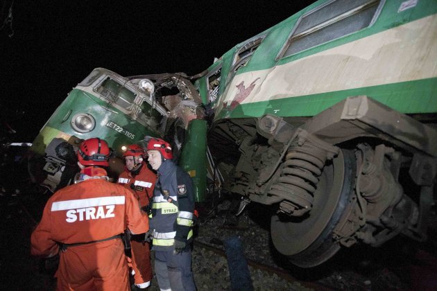 Polish emergency services stand at the site of a train crash near the town of Szczechociny