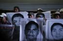 Relatives of the 43 missing students of the Ayotzinapa teachers' training college hold pictures of the students, during a protest at Zocalo square in Mexico City