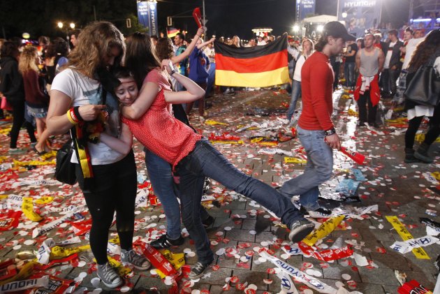 German soccer fans react during a public screening, while they watch their team play against Italy in their Euro 2012 semi-final soccer match, in Berlin