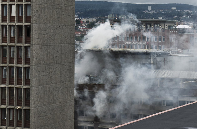 Smoke rises from buildings in Oslo, Norway, at the scene of a large explosion which tore apart several buildings Friday July 22, 2011. A loud explosion shattered windows Friday in several buildings in