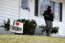 In this photo made Friday, April 3, 2015, Reginald Rounds, a volunteer with the Organization for Black Struggle, walks door-to-door while canvassing a neighborhood in Ferguson, Mo. The city is preparing for an election on Tuesday when three of six city council seats will be decided. (AP Photo/Jeff Roberson)