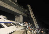 RETRANSMISSION FOR ALTERNATIVE CROP - Emergency workers and people work to help passengers from the wreckage of train after two carriages from a high-speed train derailed and fell off a bridge in Wenzhou in east China's Zhejiang province Saturday July 23, 2011. A Chinese news agency says there is no immediate word on casualties.(AP Photo) CHINA OUT
