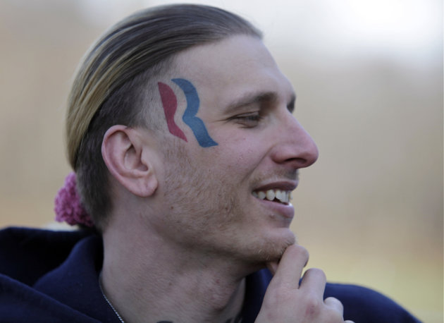 Eric Hartsburg, 30, poses for a photo showing his Romney-Ryan election logo tattoo Friday, Nov. 30, 2012 in Michigan City, Ind. Hartsburg, a professional wrestler, said he hoped the 5-by-2-inch tattoo would make politics more fun and had initially resigned himself to keeping it, but he is now planning to have it removed. (AP Photo/Teresa Crawford)