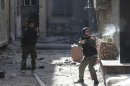 A Free Syrian Army fighter fires his rifle during heavy fighting in Mleha suburb of Damascus