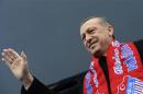 Turkey's Prime Minister Erdogan greets his supporters during an election rally of his ruling AK Party