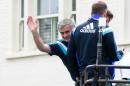 Chelsea's Portuguese manager Jose Mourinho (C) waves to supporters as the Chelsea team leave Stamford Bridge stadium in an open-top bus parade to celebrate winning the premier league in west London on May 25, 2015