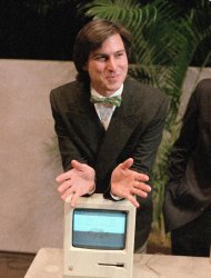 FILE - In this Jan. 24, 1984 file photo, Steve Jobs, chairman of the board of Apple Computer, leans on the new Macintosh personal computer following a shareholder's meeting in Cupertino, Ca. Apple Inc. on Wednesday, Aug. 24, 2011 said Jobs is resigning as CEO, effective immediately. He will be replaced by Tim Cook, who was the company's chief operating officer. It said Jobs has been elected as Apple's chairman. (AP Photo/Paul Sakuma, File)